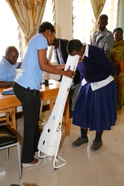 Tanzanian woman receives eye exam from SKYGEN