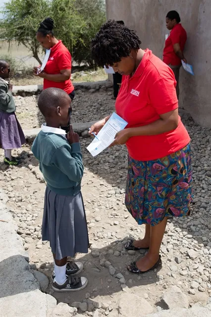 Tanzanian School Clinic lady with student